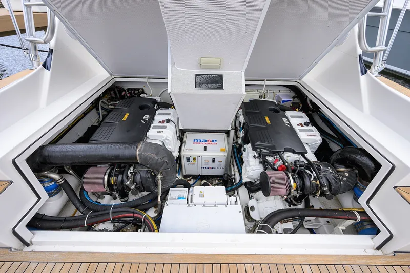 Slide: The Image of Engine compartment of a 2018 Bertram 35 Flybridge boat, showcasing dual engines and generator. - 48