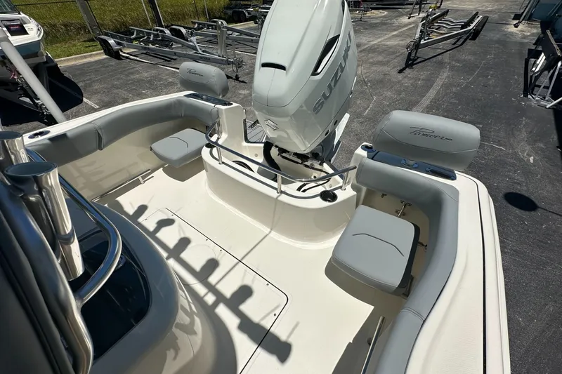 Slide: The Image of 2027 Pioneer 222 Sportfish boat interior with Suzuki engine, featuring seating and rod holders. - 11
