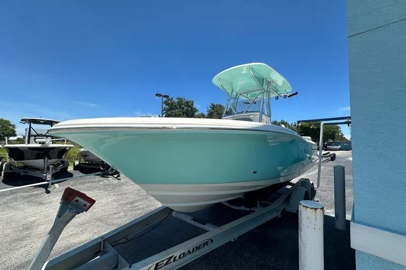 Slide: The Image of 2027 Pioneer 222 Sportfish boat on trailer under clear blue sky. - 1