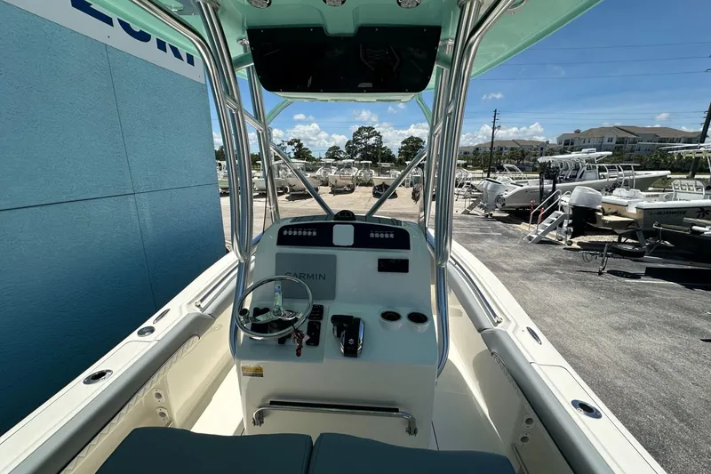 Slide: The Image of 2027 Pioneer 222 Sportfish boat interior with steering console and Garmin navigation system. - 5