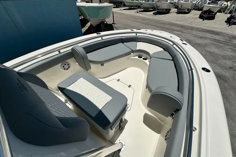 Slide: The Image of 2027 Pioneer 222 Sportfish boat interior with cushioned seating and modern design. - 7