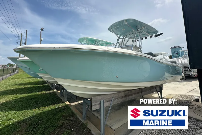 The Image of 2027 Pioneer 222 Sportfish boat displayed outdoors, powered by Suzuki Marine. - 0
