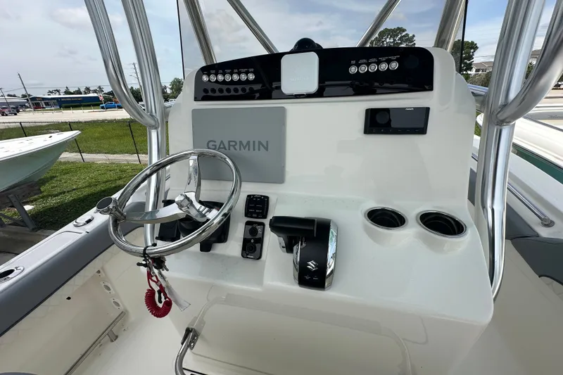Slide: The Image of Pioneer 222 Sportfish 2027 boat console with Garmin navigation and steering wheel. - 5