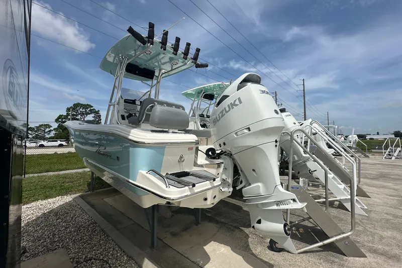 Slide: The Image of 2027 Pioneer 222 Sportfish boat with Suzuki outboard motor on display. - 2