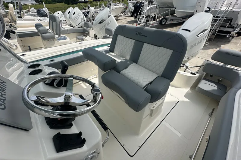Slide: The Image of 2027 Pioneer 222 Sportfish boat interior with steering wheel and seating. - 9