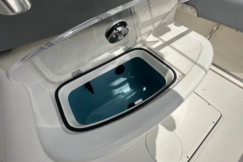 Slide: The Image of Livewell on 2027 Pioneer 222 Sportfish boat, featuring a clear lid and white interior. - 11