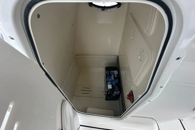 Slide: The Image of Storage compartment of 2027 Pioneer 222 Sportfish boat, featuring a battery box. - 8