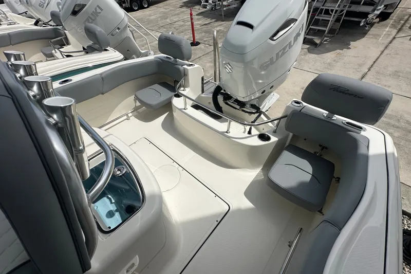 Slide: The Image of 2027 Pioneer 222 Sportfish boat with Suzuki outboard motor, featuring spacious seating and rod holders. - 10