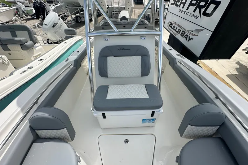 Slide: The Image of 2027 Pioneer 222 Sportfish boat interior with cushioned seating and sleek design. - 7