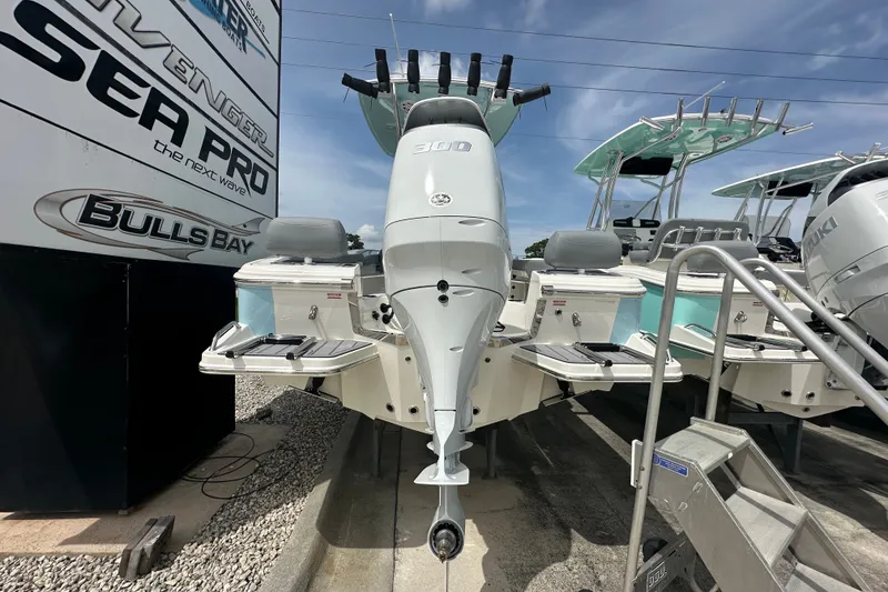 Slide: The Image of 2027 Pioneer 222 Sportfish boat with powerful outboard motor, displayed at a dealership. - 3