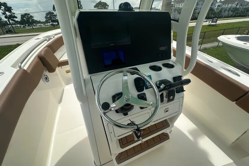 Slide: The Image of 2027 Pioneer 270 Pelagic boat helm with steering wheel and control panel. - 4