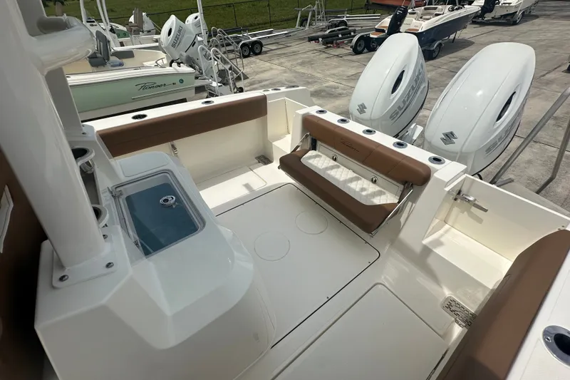 Slide: The Image of 2027 Pioneer 270 Pelagic boat interior with dual Suzuki outboard motors. - 10