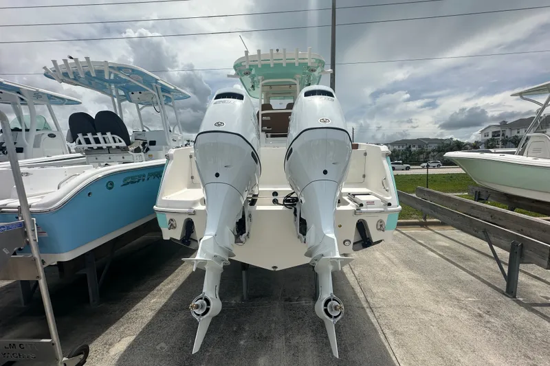 Slide: The Image of 2027 Pioneer 270 Pelagic boat with dual outboard motors, displayed outdoors. - 3