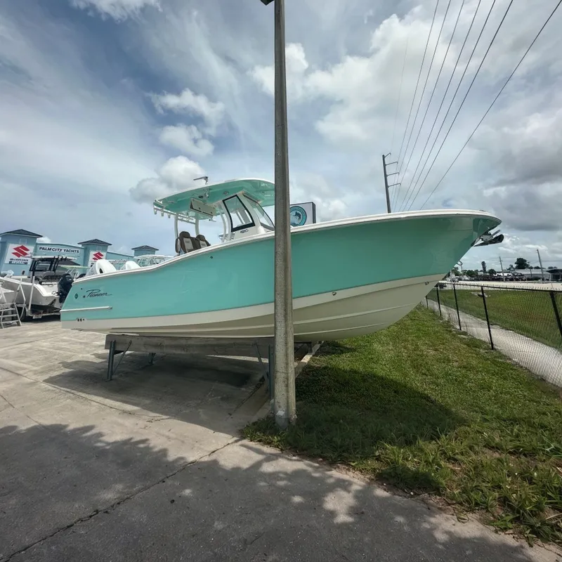Slide: The Image of A turquoise 2027 Pioneer 270 Pelagic is parked on a lot next to a fence. - 1