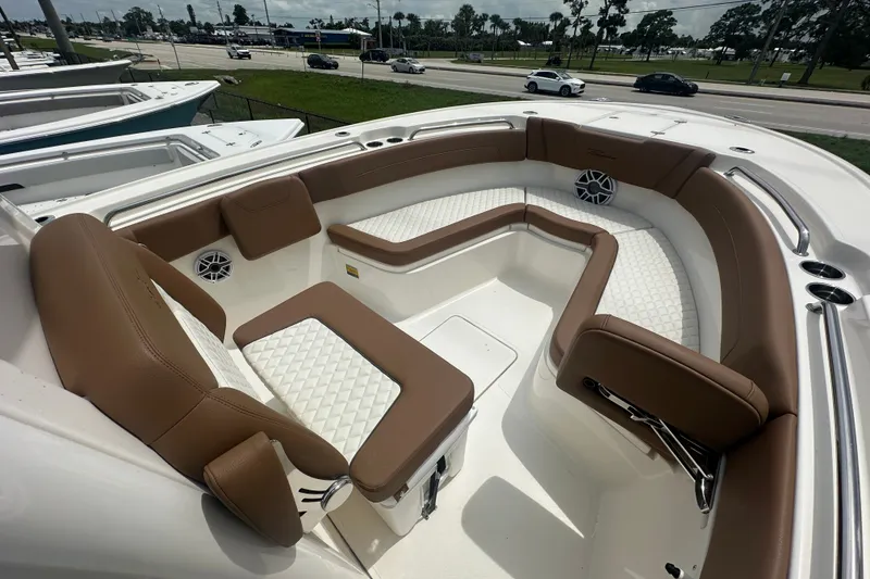 Slide: The Image of Luxurious seating area on 2027 Pioneer 270 Pelagic boat with brown and white upholstery. - 6