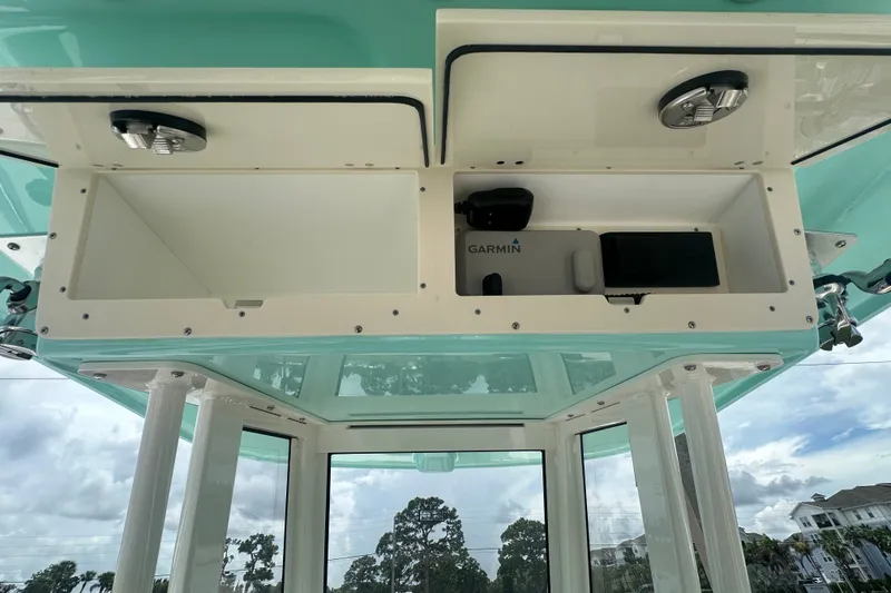 Slide: The Image of Interior view of 2027 Pioneer 270 Pelagic boat with storage compartments and Garmin equipment. - 5