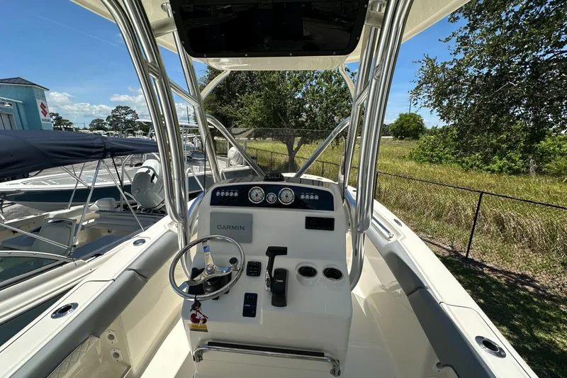 Slide: The Image of 2027 Pioneer 202 Islander boat cockpit with steering wheel and Garmin navigation system. - 5
