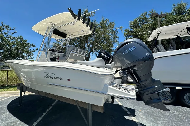 Slide: The Image of 2027 Pioneer 202 Islander boat with Yamaha outboard motor, parked outdoors. - 3