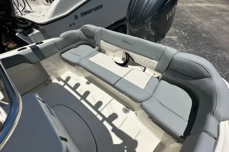 Slide: The Image of 2027 Pioneer 202 Islander boat interior with gray seating and Yamaha engine. - 10