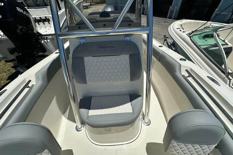 Slide: The Image of 2027 Pioneer 202 Islander boat interior with gray seating and stainless steel frame. - 7