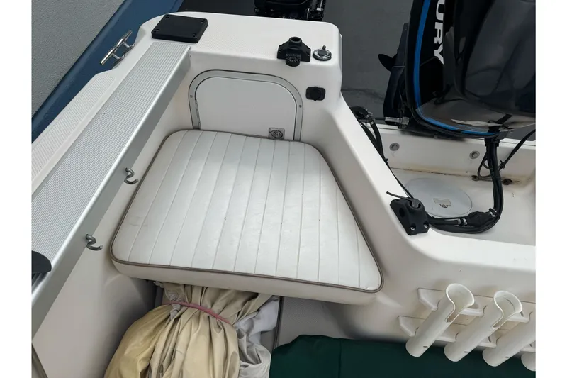 Slide: The Image of 2003 Trophy 1802 Walkaround boat interior with cushioned seating and storage compartment. - 18