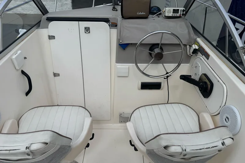Slide: The Image of 2003 Trophy 1802 Walkaround boat interior with steering wheel and two seats. - 9