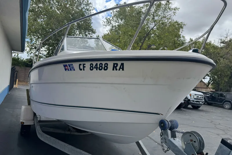 Slide: The Image of 2003 Trophy 1802 Walkaround boat on trailer, parked outdoors. - 4
