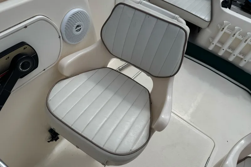 Slide: The Image of 2003 Trophy 1802 Walkaround boat seat with white upholstery and control panel. - 12