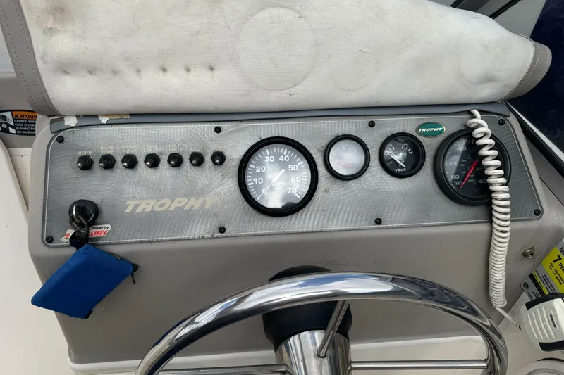 Slide: The Image of 2003 Trophy 1802 Walkaround boat dashboard with gauges and controls. - 22