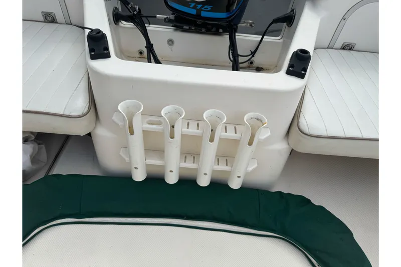 Slide: The Image of 2003 Trophy 1802 Walkaround boat interior with rod holders and seating. - 16