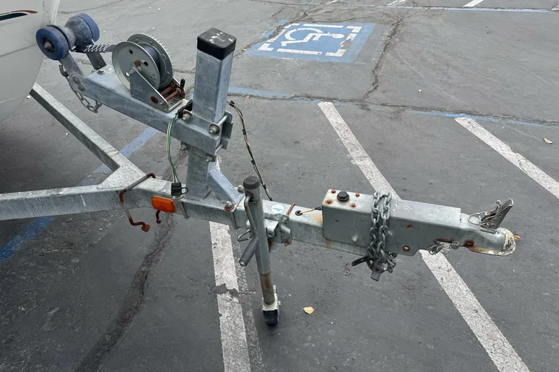 Slide: The Image of Trailer hitch of a 2003 Trophy 1802 Walkaround boat in a parking lot. - 3