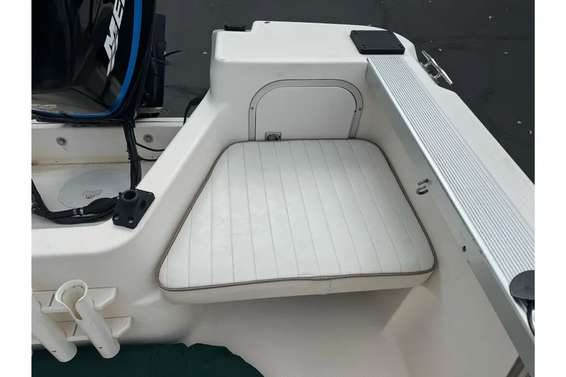 Slide: The Image of 2003 Trophy 1802 Walkaround boat interior with cushioned seating and storage compartment. - 17