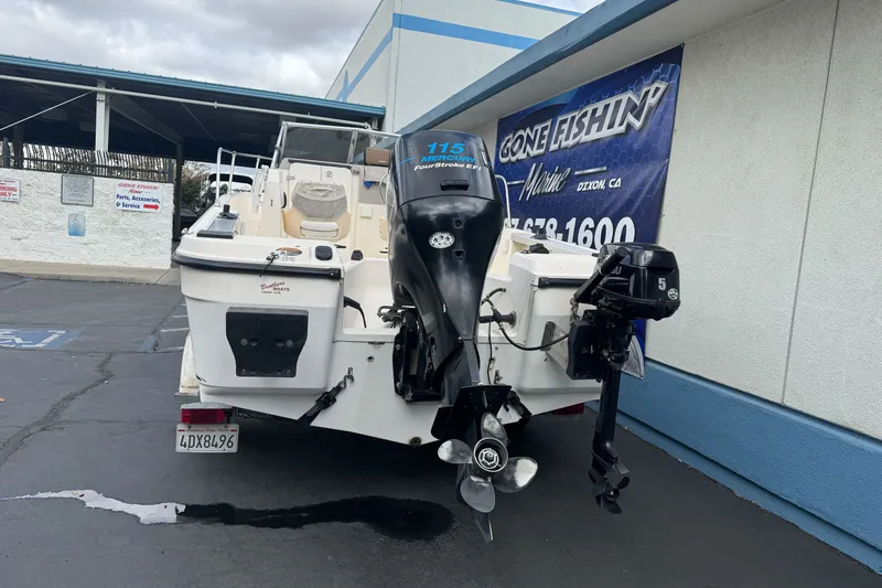 Slide: The Image of 2003 Trophy 1802 Walkaround boat with outboard motors at a marine service center. - 7