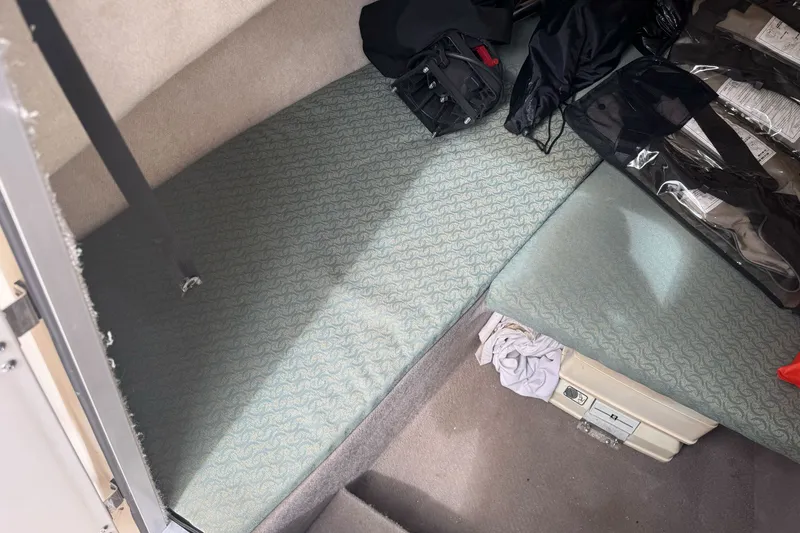Slide: The Image of Interior cabin of a 2003 Trophy 1802 Walkaround boat with storage and seating. - 24