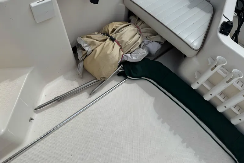 Slide: The Image of 2003 Trophy 1802 Walkaround boat interior with stored equipment and seating area. - 14