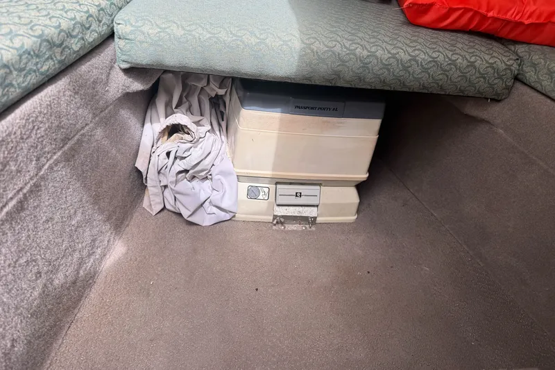 Slide: The Image of 2003 Trophy 1802 Walkaround cabin with portable toilet and storage space. - 25
