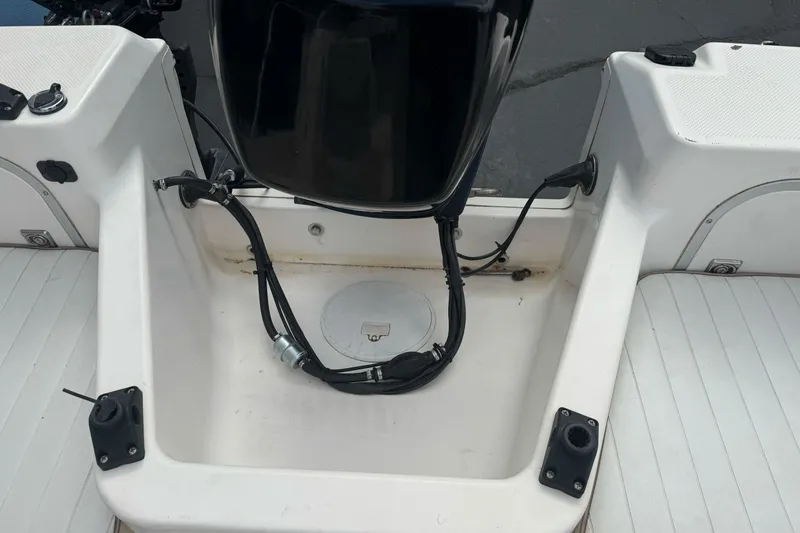 Slide: The Image of 2003 Trophy 1802 Walkaround boat interior with engine and seating area. - 19