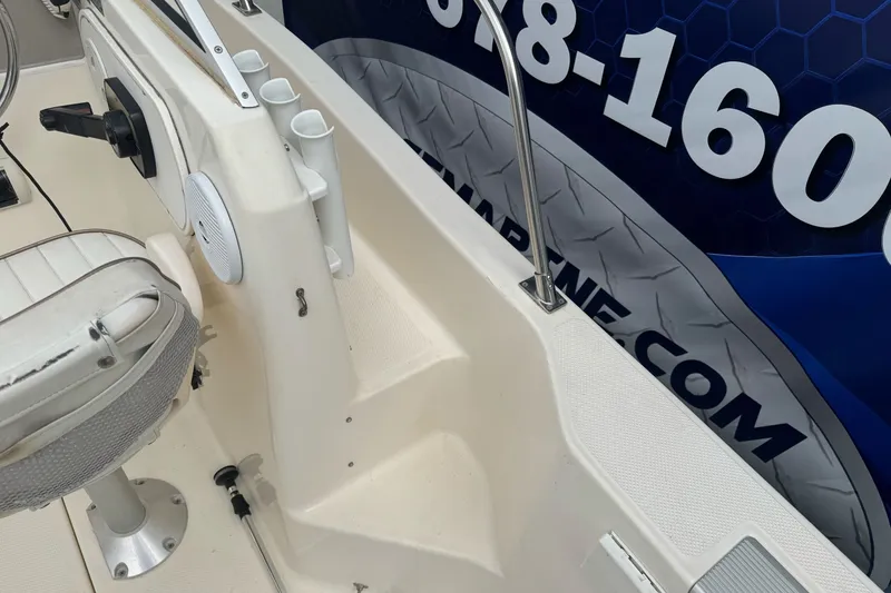 Slide: The Image of 2003 Trophy 1802 Walkaround boat interior with seating and rod holders. - 20