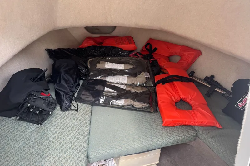 Slide: The Image of Interior of a 2003 Trophy 1802 Walkaround boat with life jackets and gear. - 15