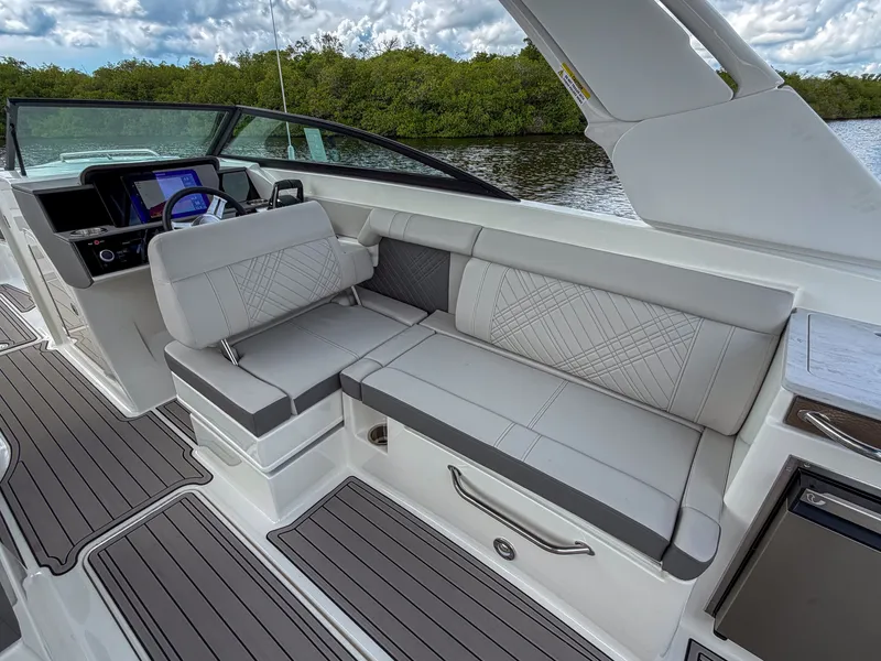 Slide: The Image of The image shows the cockpit of a 2027 Sea Ray SDX 290 Outboard with sleek seating. - 13