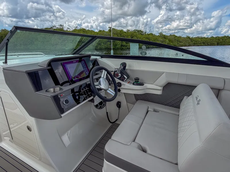 Slide: The Image of The image shows the cockpit of a 2027 Sea Ray SDX 290 Outboard with a modern helm. - 16