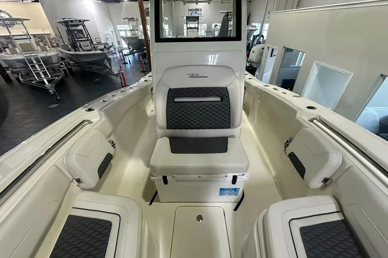 Slide: The Image of 2026 Pioneer 250 Pelagic boat interior with cushioned seating and modern design. - 7