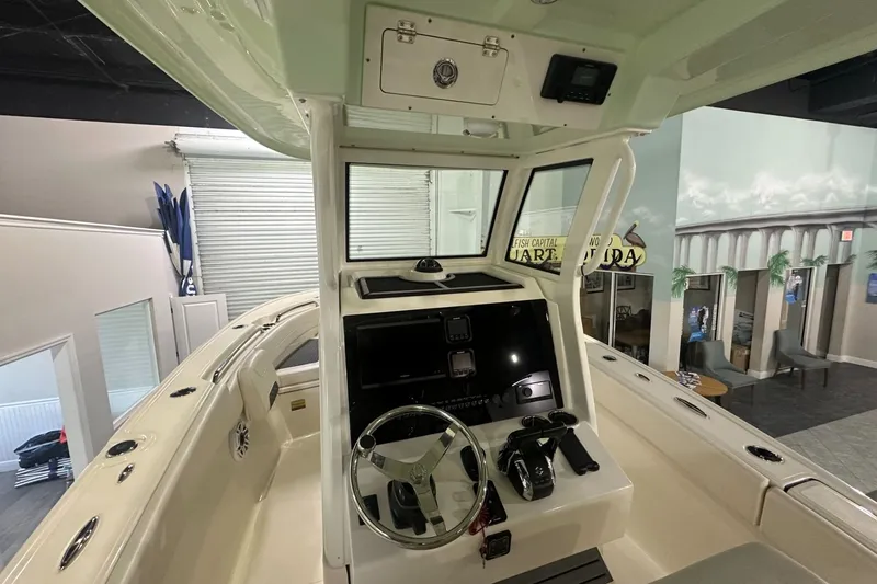 Slide: The Image of Interior view of 2026 Pioneer 250 Pelagic boat cockpit with steering wheel and controls. - 4