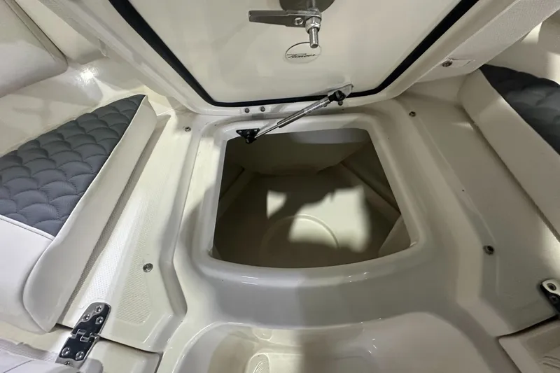 Slide: The Image of 2026 Pioneer 250 Pelagic boat storage compartment with cushioned seating and secure latch. - 9