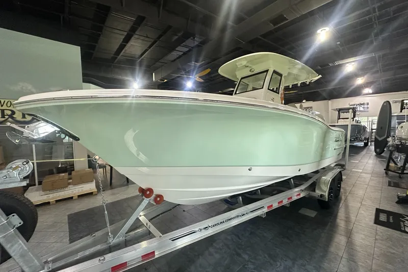 Slide: The Image of 2026 Pioneer 250 Pelagic boat displayed indoors on a trailer. - 1