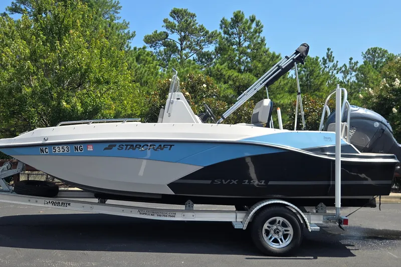 The Image of 2025 Starcraft SVX 191 OB CC boat on trailer, parked outdoors. - 0