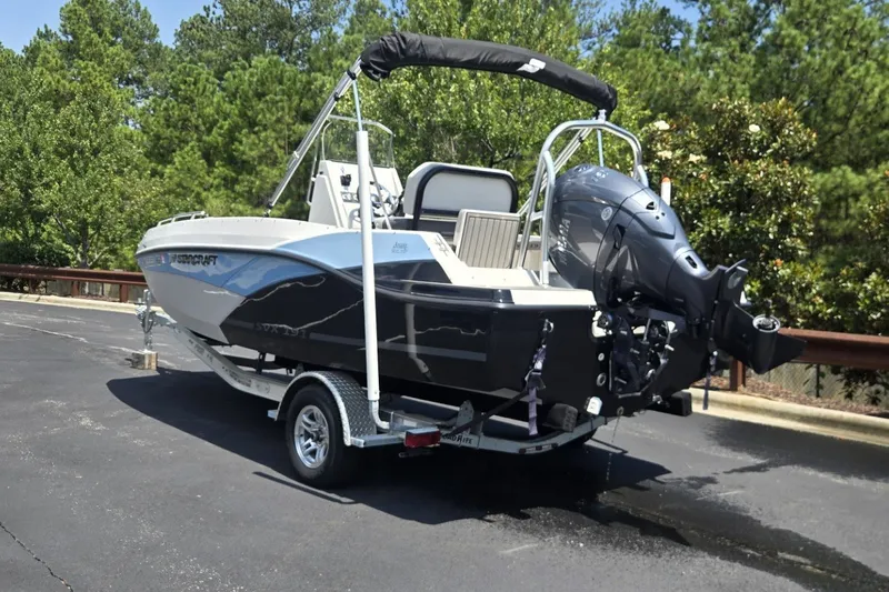 Slide: The Image of 2025 Starcraft SVX 191 OB CC boat on trailer, parked outdoors. - 9