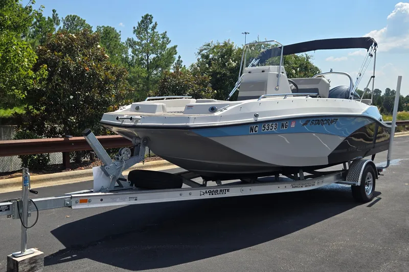 Slide: The Image of 2025 Starcraft SVX 191 OB CC boat on trailer, parked outdoors. - 3