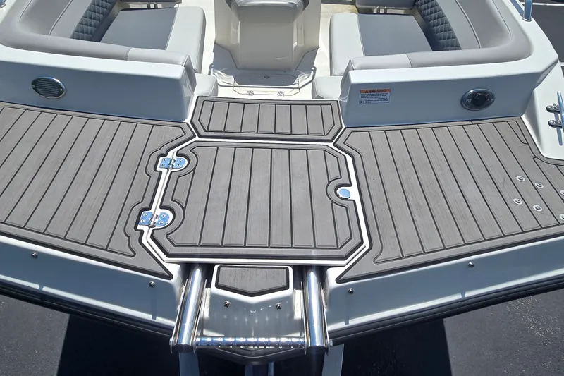 Slide: The Image of 2025 Starcraft SVX 191 OB CC boat deck with gray non-slip surface and seating area. - 6