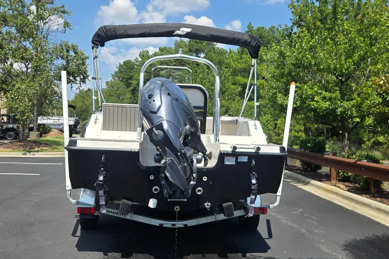 Slide: The Image of 2025 Starcraft SVX 191 OB CC boat with outboard motor on trailer, parked outdoors. - 1
